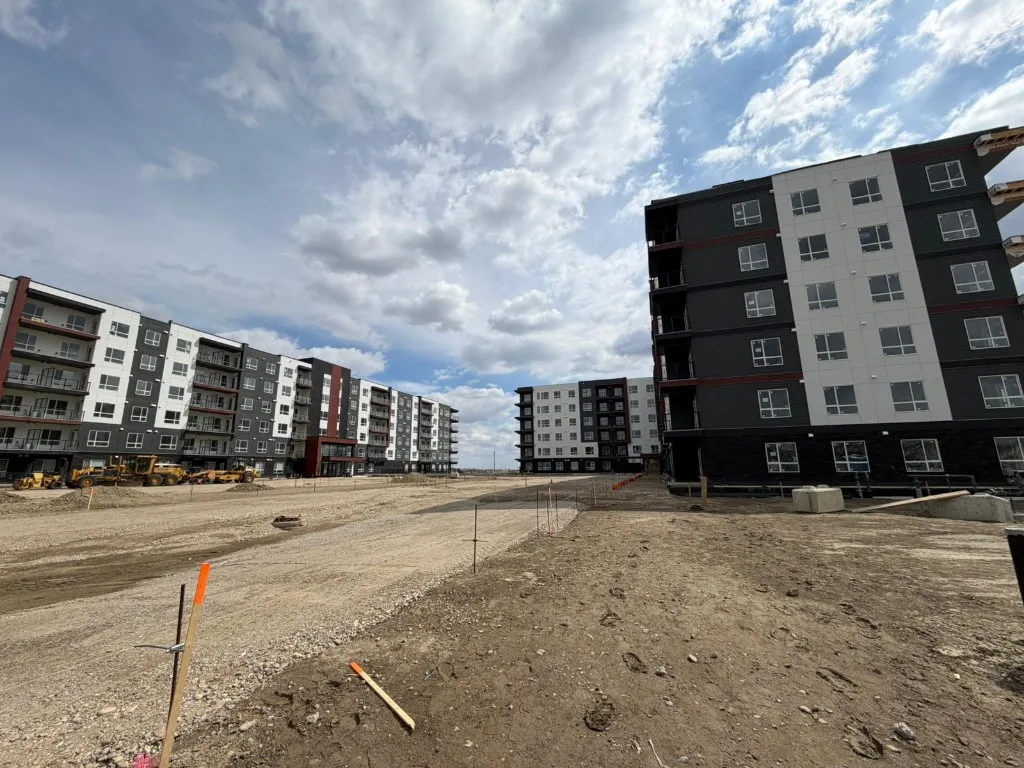 Large multi-story apartment complex under exterior construction