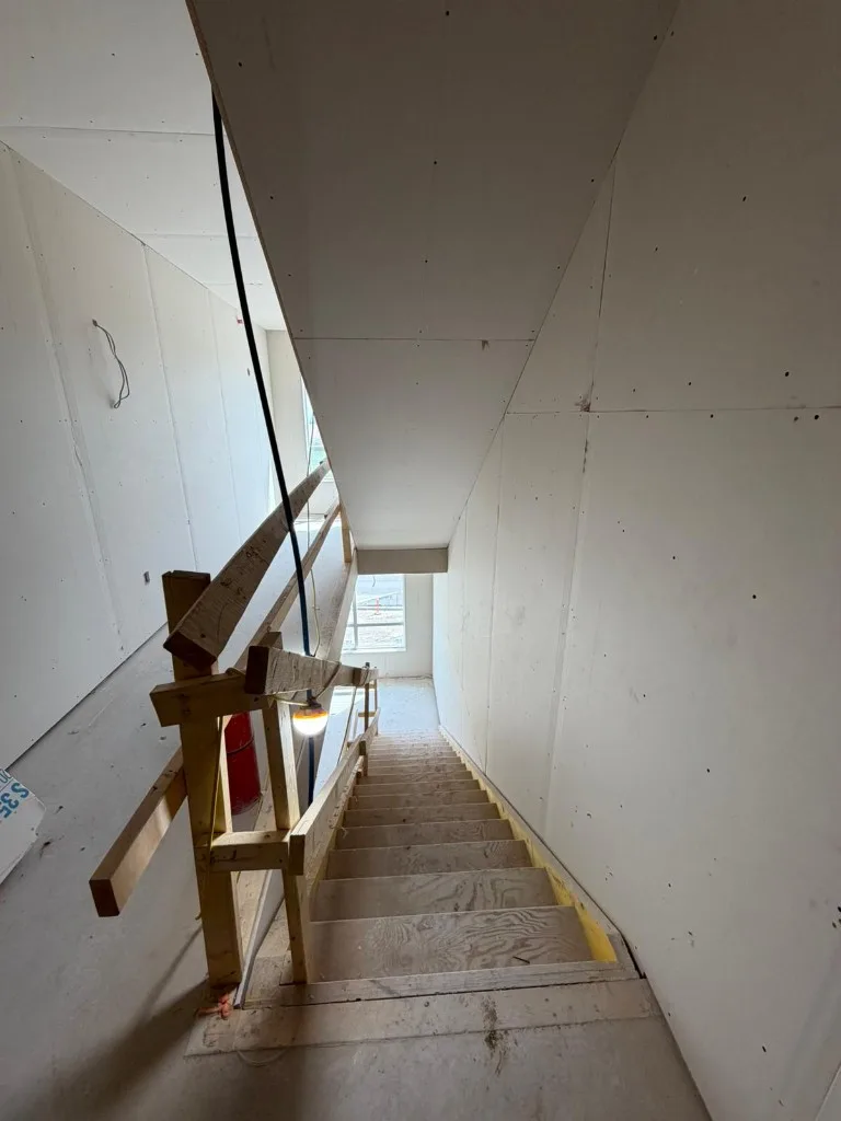 Recessed ceiling frame with pot lights and HVAC boots before drywall