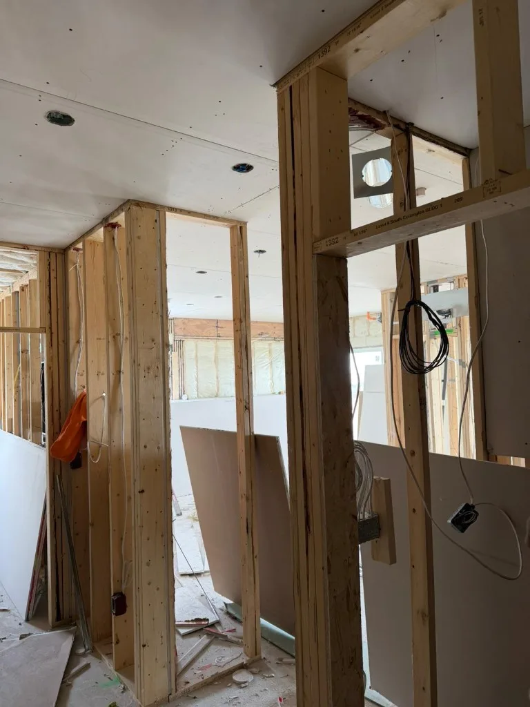Drywall installed on walls and bulkhead with pot light and outlet cutouts