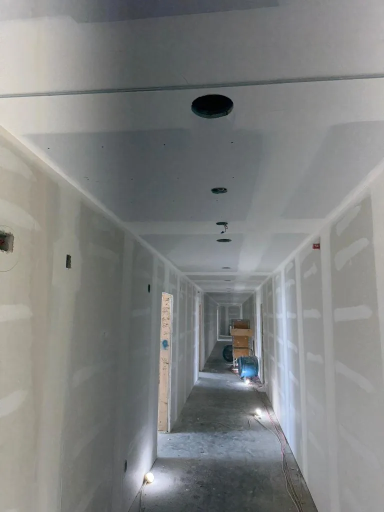 Drywall panels leaned against studs during installation phase