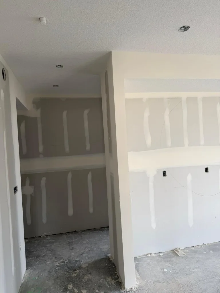 Ceiling and wall drywall with screw pattern before taping