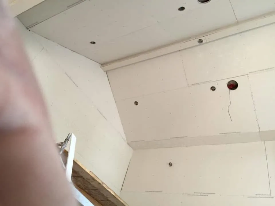 Multi-level framing view with ceiling joists and insulation