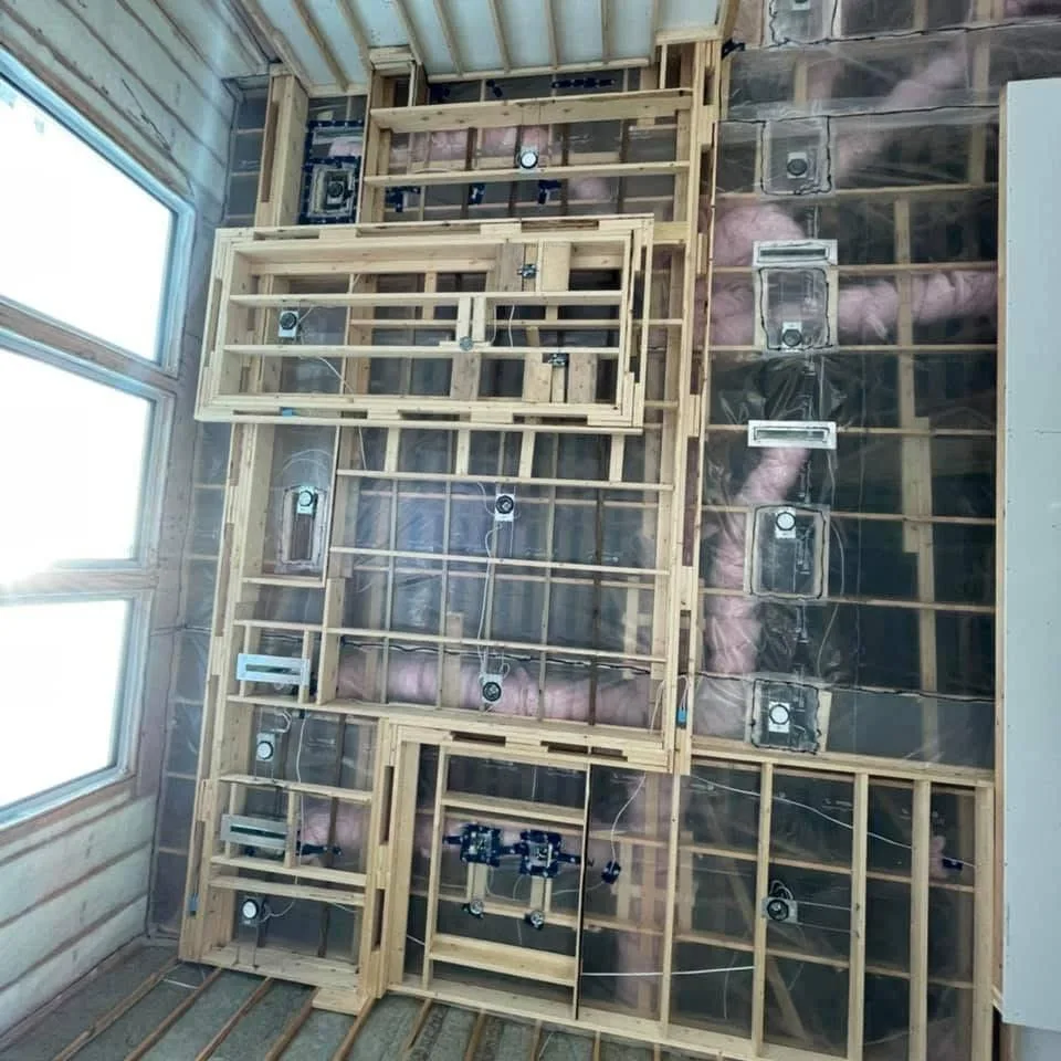 Drywall worker on site with tool belt and wall panels