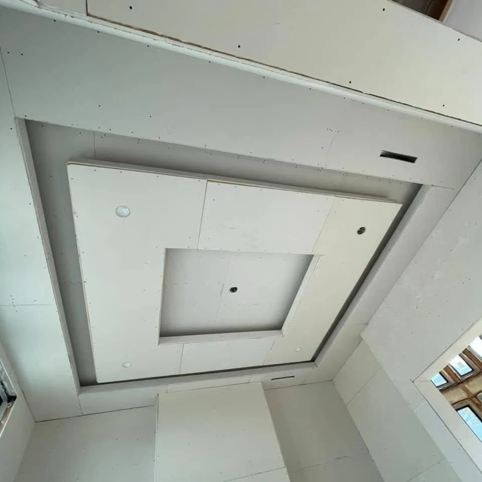 Interior drywall with outlet boxes and range hood duct opening