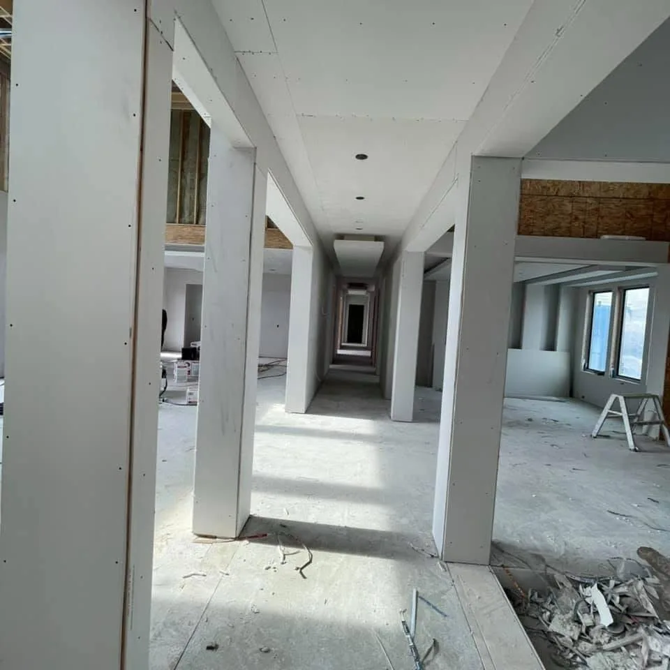 Basement framing with tray ceiling tiers and loose drywall